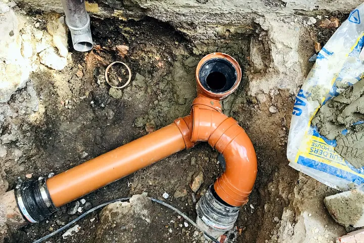A replaced underground drain run in an excavated trench